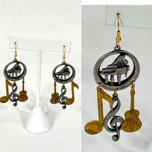 Silver-tone and gold-tone statement dangle musical earrings.